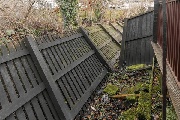Storm-damaged fence requiring insurance claim