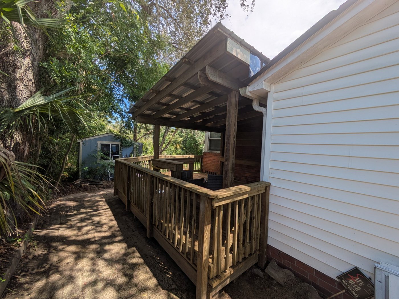 Deck project after — Prepped grade rebuilt into a code-compliant elevated deck with railings and steps — Jacksonville FL by P1Mitigators