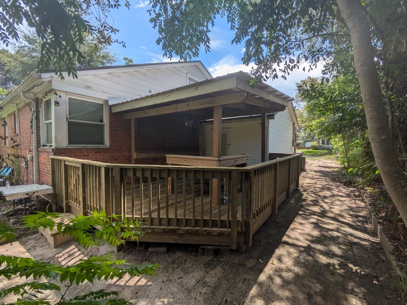 Deck project after — Mildewed siding and dead space turned into a clean covered bar deck — Jacksonville FL by P1Mitigators