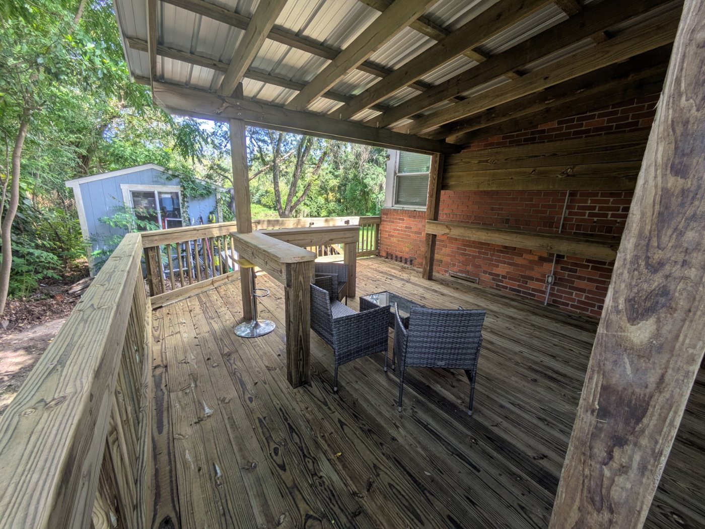 Deck project after — Junk-filled backyard turned into a finished deck ready for entertaining — Jacksonville FL by P1Mitigators