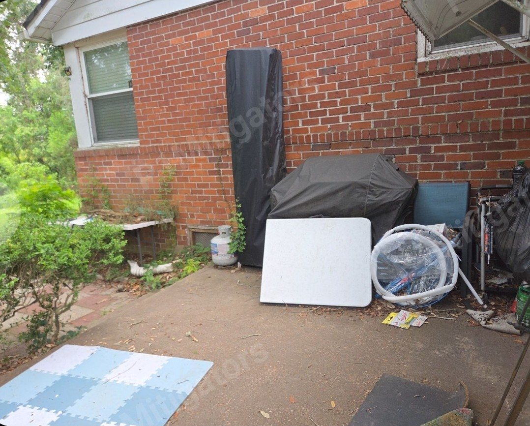 Deck project before — Cluttered back corner rebuilt into a shaded outdoor living space — Jacksonville FL by P1Mitigators