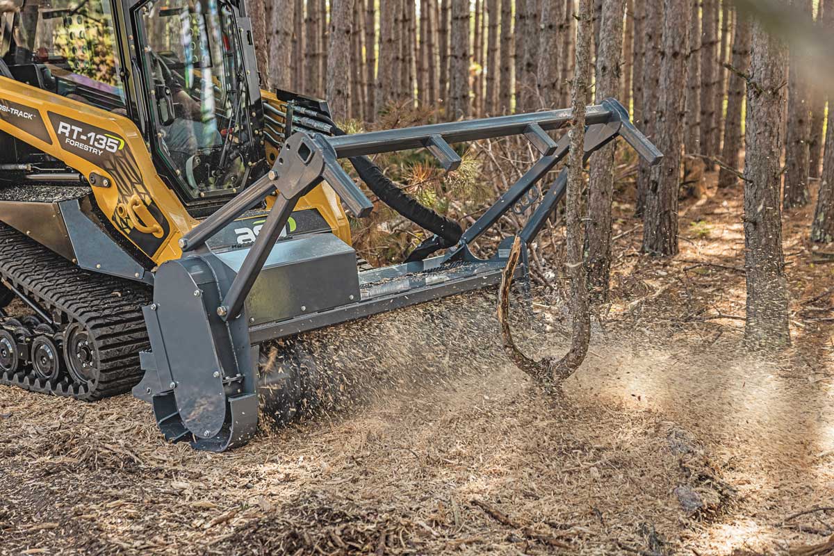 Forestry mulcher grinding brush and small trees into mulch on a Duval County land-clearing job site