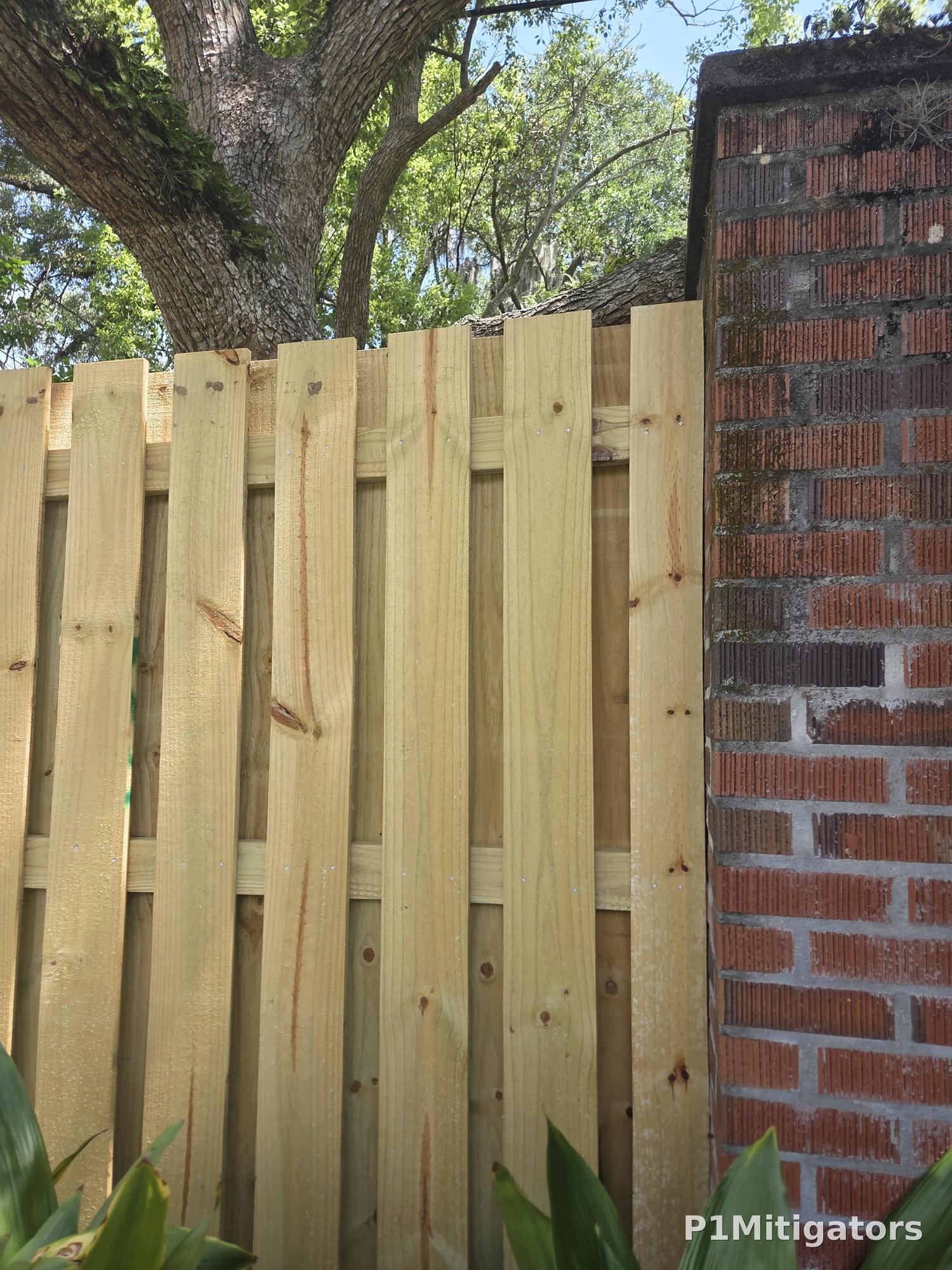 Shadowbox fence board detail with brick pillar