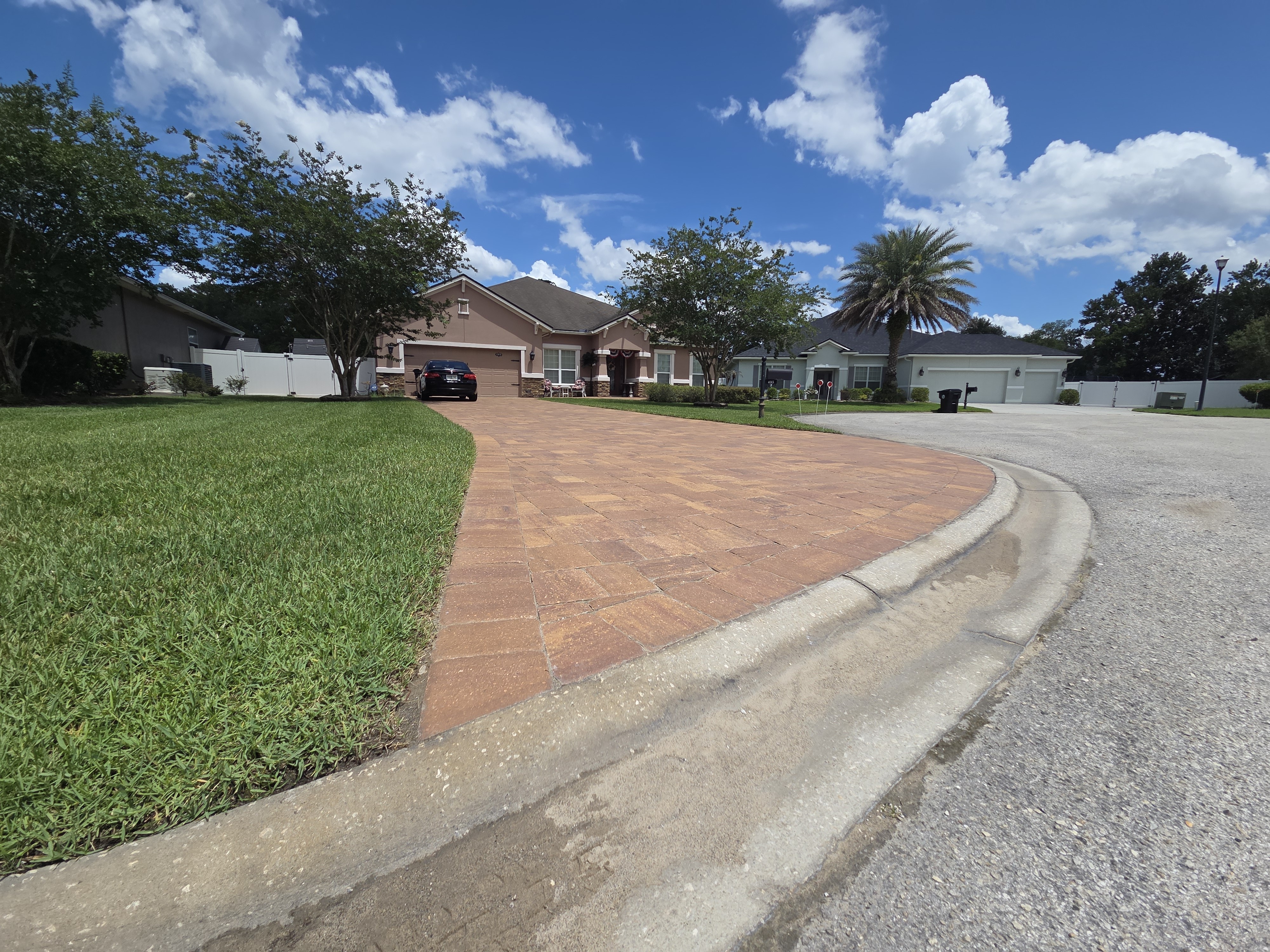 Curved brick paver driveway — sweeping design with border detail
