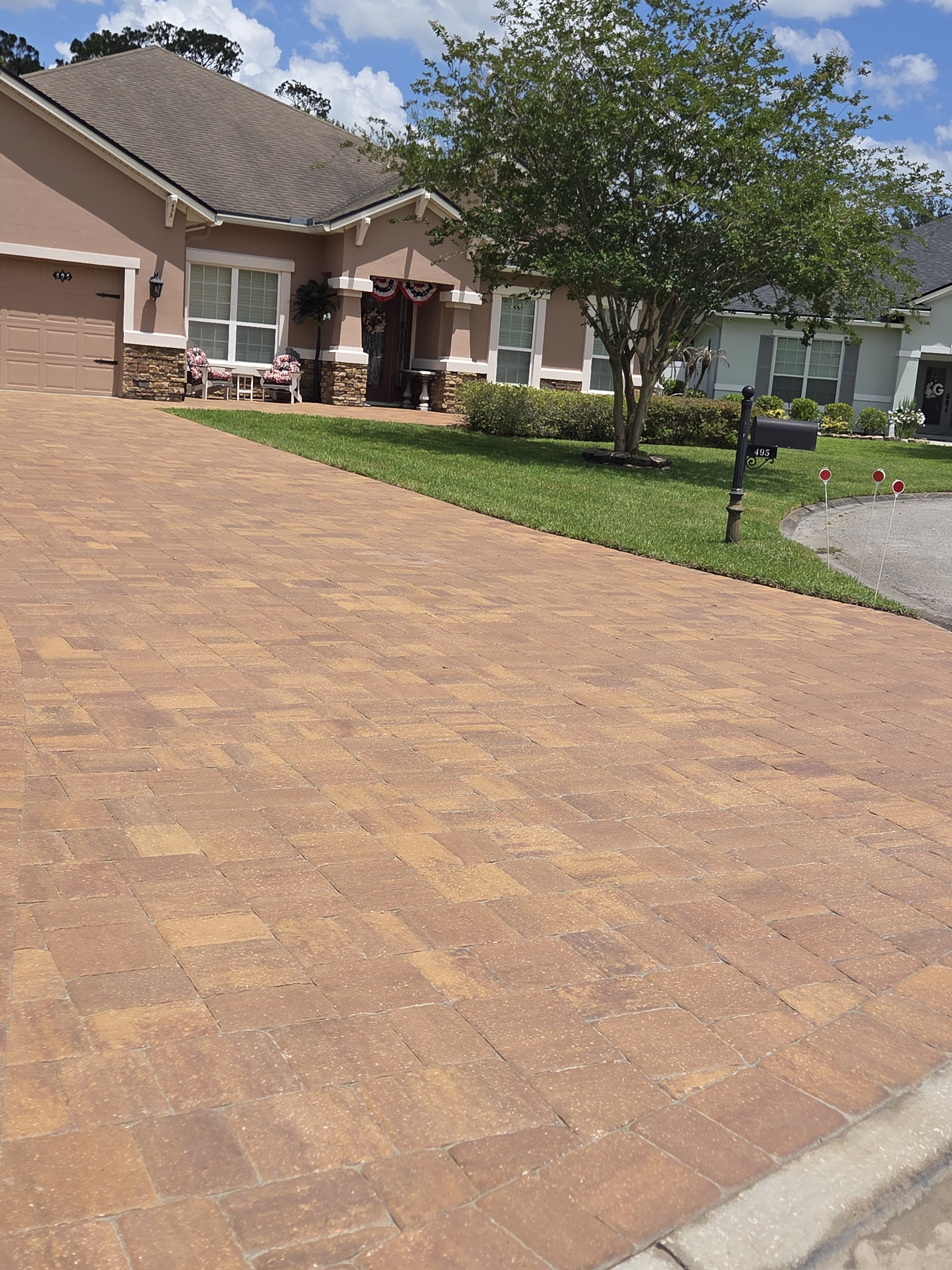 Brick paver driveway close-up — herringbone pattern and border cuts