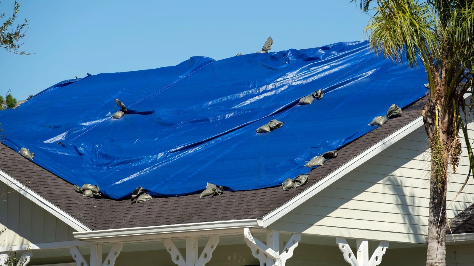 Heavy-duty emergency roof tarp installed on a storm-damaged roof in Jacksonville FL