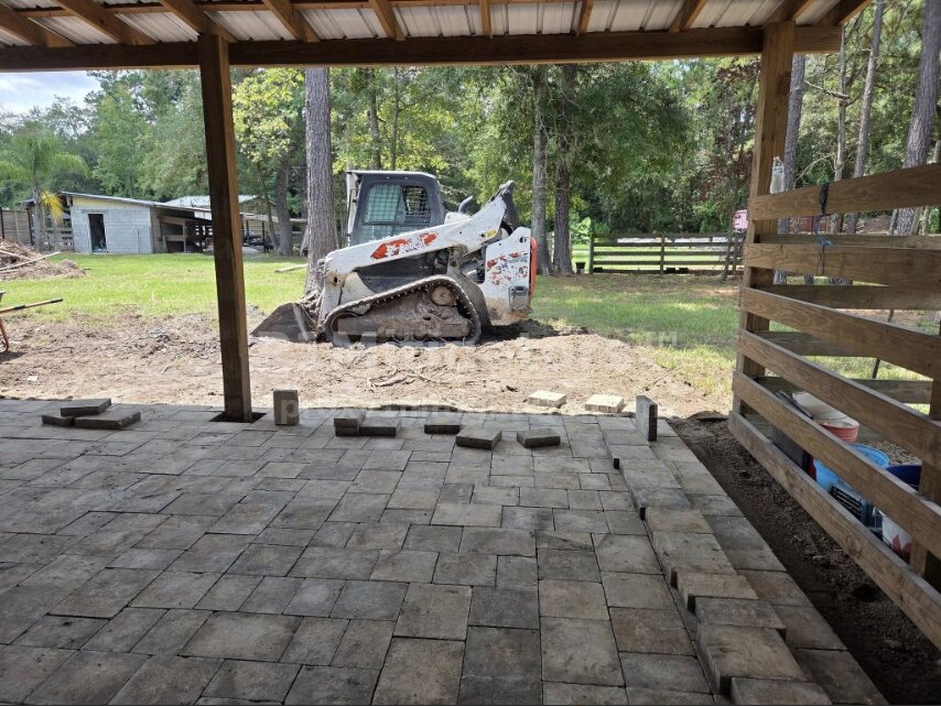 Bobcat under covered patio — finished paver area