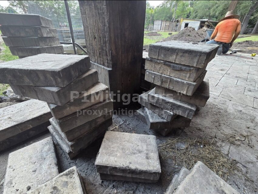 Stacked paver blocks around a post — materials staged for install