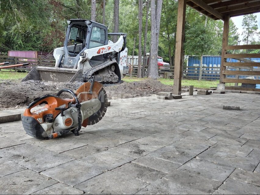 Stihl cut-off saw on finished pavers with Bobcat skid steer